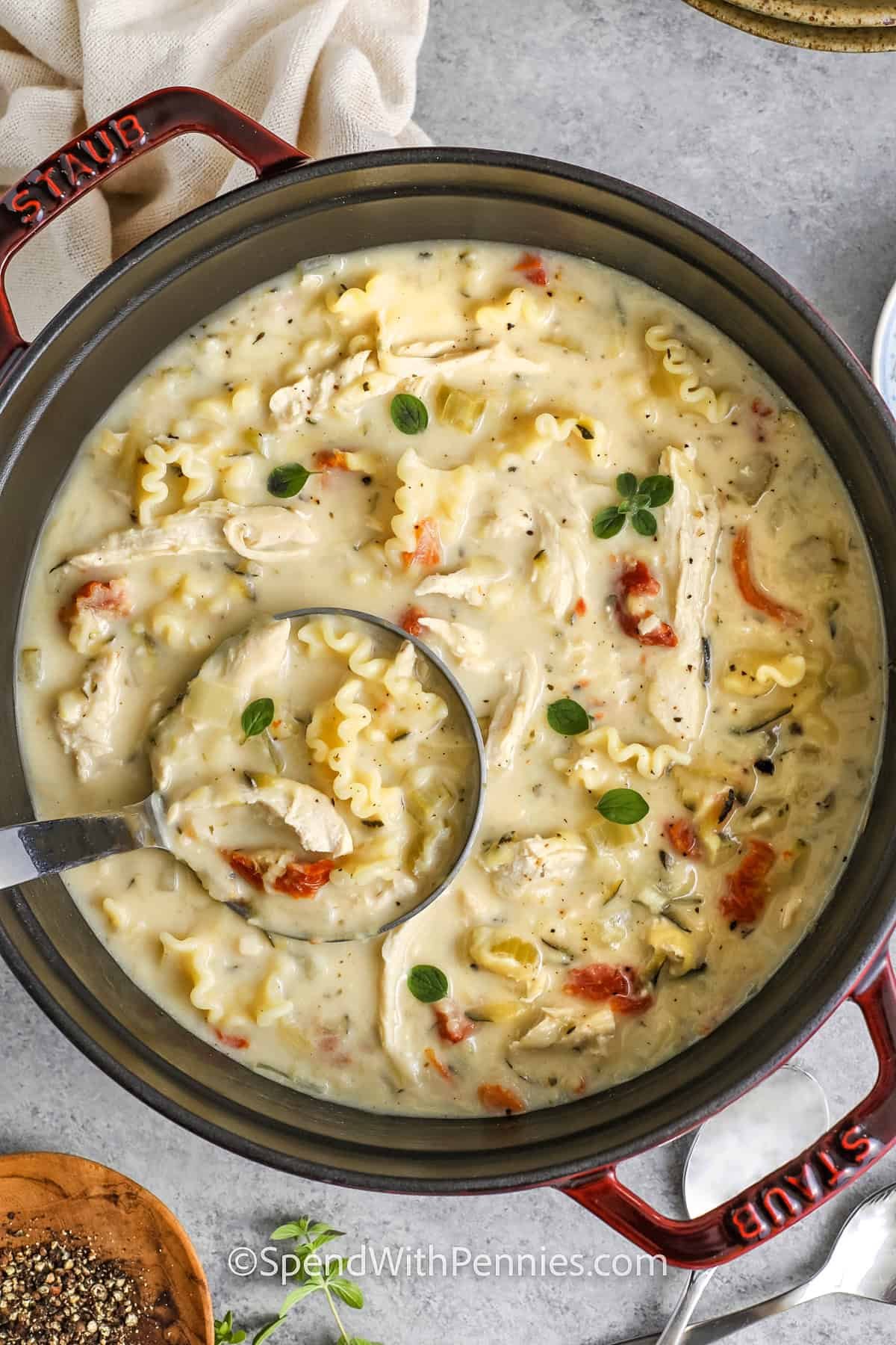 Dutch oven full of white lasagna soup with a ladle