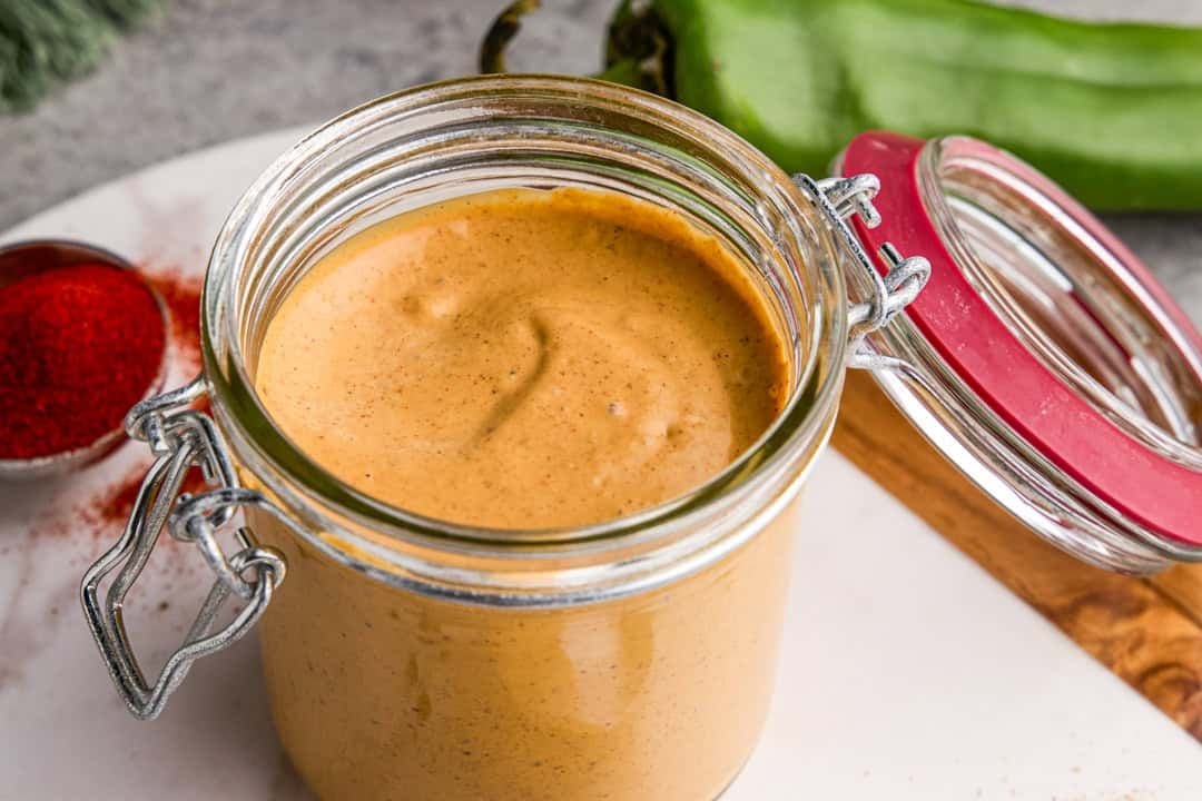 Cowboy Dressing in a glass jar with ingredients surrounding it.