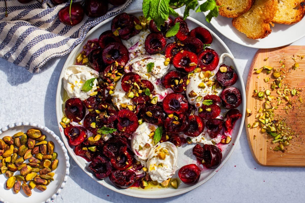 burrata with crushed cherries and pistachios