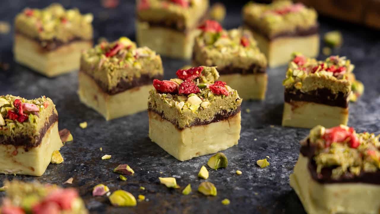pieces of Dubai Chocolate Fudge with a pistachio base, chocolate ganache layer, and a kataifi topping/