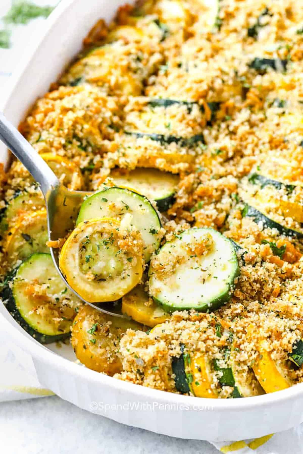 Squash Casserole in a dish with a spoon