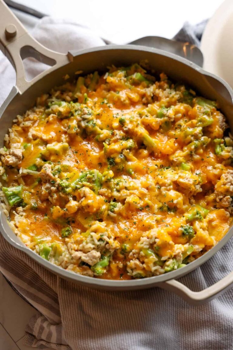 Cheesy chicken and broccoli skillet on a countertop.