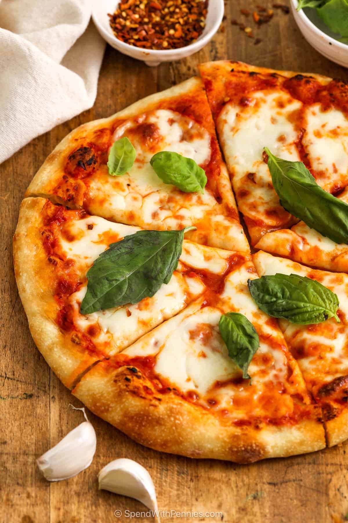 Sliced Margherita pizza with fresh basil