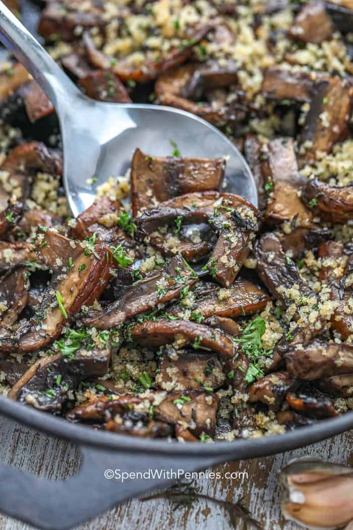 Spoon in a pan of Garlic Butter Portobello Mushrooms
